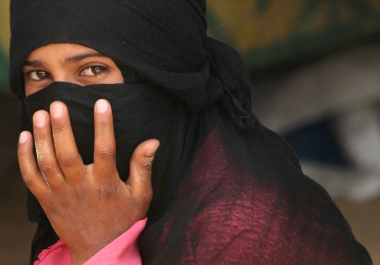 A Beduin woman from al-Aweida tribe sits next to her tent in north Sinai