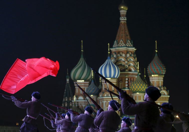 Russian servicemen, dressed in historical uniforms, take part in a military parade rehearsal in front of St. Basil's Cathedral in Red Square in central Moscow