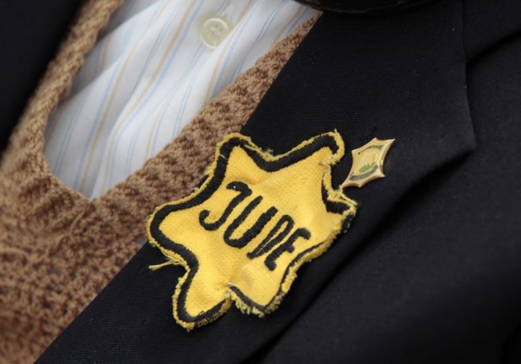 A Holocaust survivor wears a yellow star during a ceremony at the Yad Vashem Holocaust Memorial in Jerusalem