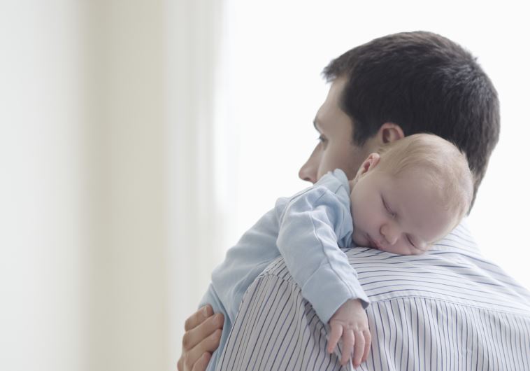 A father holds his child [Illustrative]
