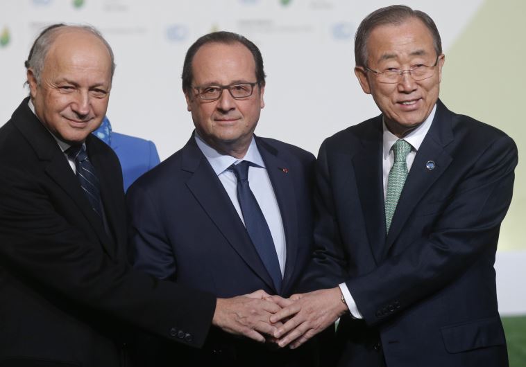 French President Francois Hollande (C) and French Foreign Affairs Minister Laurent Fabius (L) welcome United Nations Secretary General Ban Ki-moon as he arrives for the opening day of the World Climate Change Conference 2015
