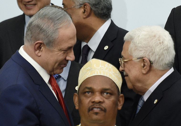 PM Netanyahu talks with President Abbas during a family photo for the opening day of the World Climate Change Conference 2015 