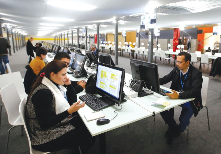 JOURNALISTS AT work at their desks.