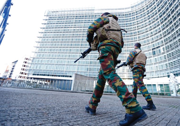 BELGIAN SOLDIERS patrol outside European Commission headquarters in Brussels as police searched the area following the Paris terror attacks in mid-November that claimed the lives of 130 people