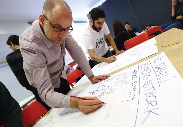 German cartoonist Reinhard Kleist (left) working with other international artists on the Respekt project at Holon’s Israeli Cartoon Museum