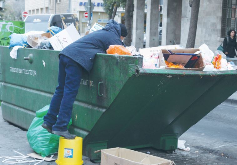A man in Jerusalem searching through the garbage