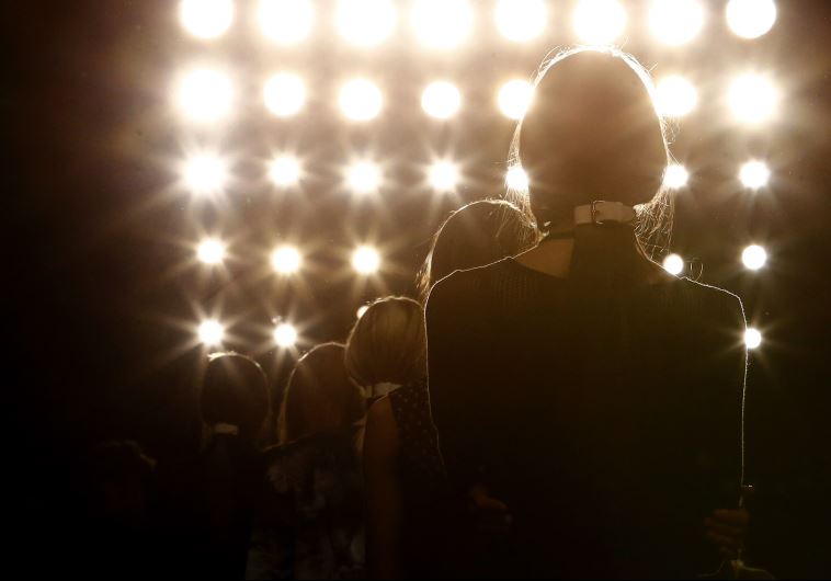 Models listen to final instructions to present creations by Marina Hoermanseder at the Berlin Fashion Week Autumn/Winter 2014 in Berlin