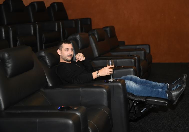 DJ and bar owner Mike Zof gets cozy with champagne at his personal screening of the Star Wars film in Petach Tikva, December 16, 2015.
