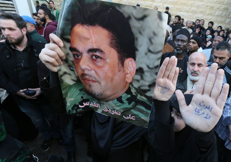 Lebanese mourners hold portraits of Lebanese militant Samir Kantar during his funeral procession