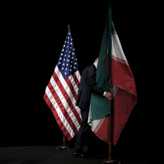 A staff member removes the Iranian flag from the stage during the Iran nuclear talks in Vienna, Austria July 14, 2015