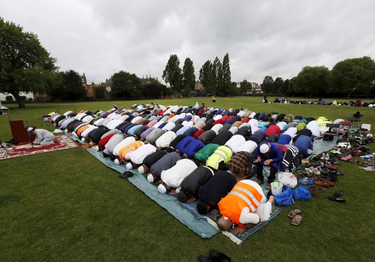 Muslims perform prayers for Eid-al Fitr to mark the end of the holy fasting month of Ramadan at a park in London