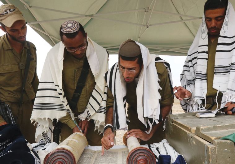 RELIGIOUS SOLDIERS pray near the Gaza border during Operation Protective Edge in July 2014.