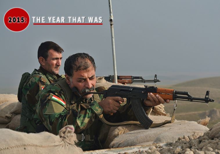 Two Kurdish members of the Kurdistan Freedom Party (PAK) look through their gun sights toward Islamic State positions on the front lines northwest of Kirkuk