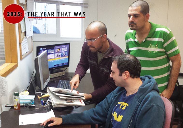Outgoing manager of jpost.1eye.us, Nati Gabbay (right), goes over the latest headlines with his staff in our Tel Aviv office