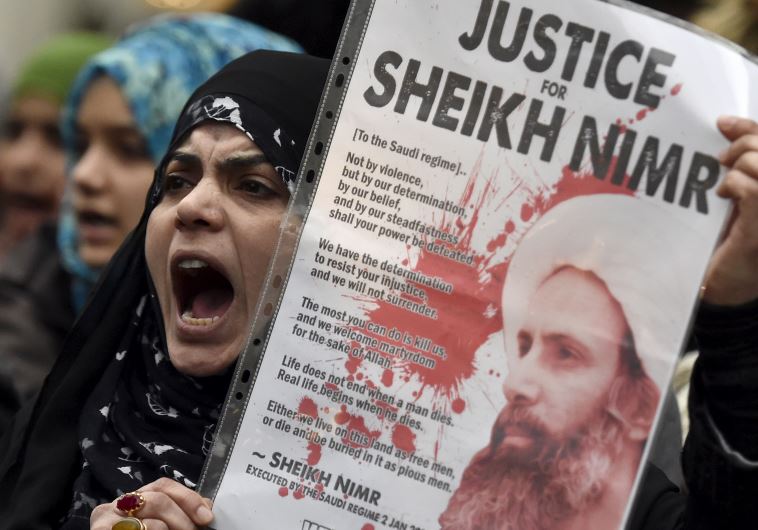 A protester holds a placard during a demonstration against the execution of Shi'ite cleric Sheikh Nimr al-Nimr in Saudi Arabia, outside the Saudi Arabian Embassy in London, Britain, January 3, 2016