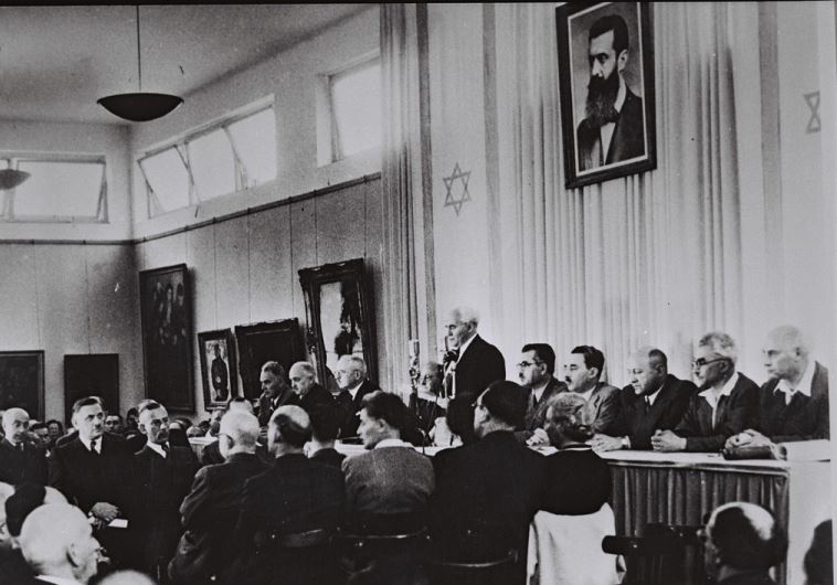 David Ben-Gurion, flanked by the members of his provisional government, reads the Declaration of Independence in the Tel Aviv Museum Hall