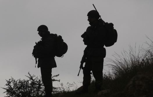 IDF soldiers stand guard during a demonstration by Palestinians against the closure of the main road in Jabaa area south of the West Bank city of Bethlehem