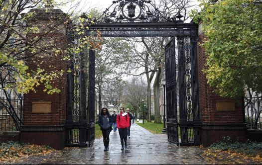 STUDENTS WALK on the campus of a university in Connecticut