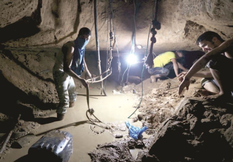 Gazans repair a smuggling tunnel, flooded by the Egyptians, beneath the border between Egypt and Gaza, November 26.