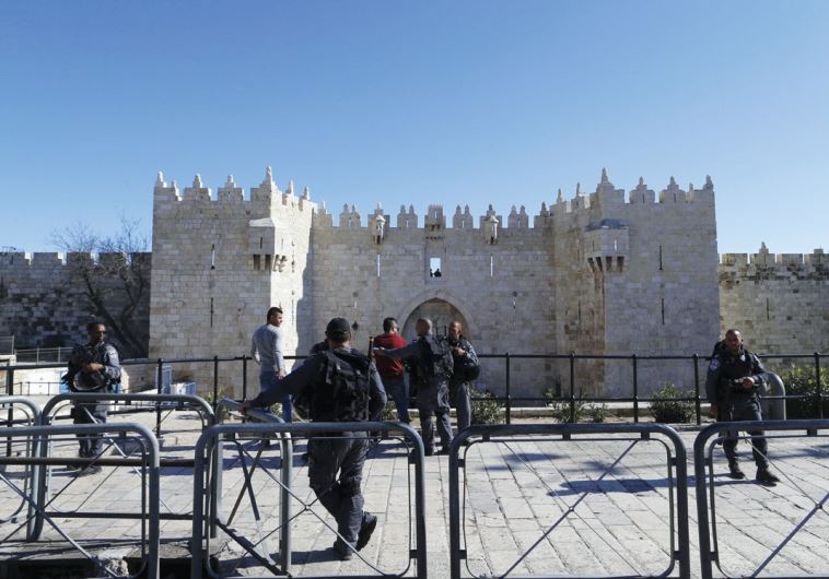 BORDER POLICE frisk a Arab man in front of Jerusalem’s Damascus Gate, the scene of much recent violence.