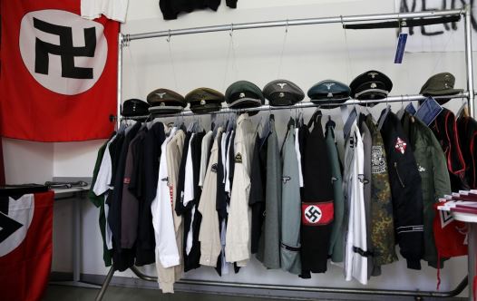 Nazi uniforms and a Swastika flag that were confiscated by the Berlin police during raids against German neo-Nazis