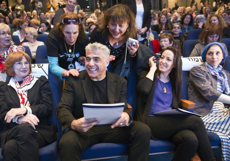 Yesh Atid leader Yair Lapid and his wife Lihi attend a women's committee convention in Tel Aviv