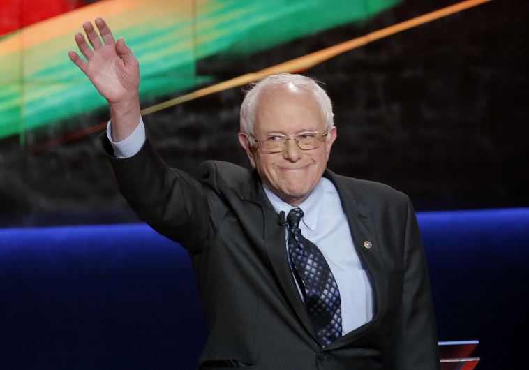 Democratic US presidential candidate and U.S. Senator Bernie Sanders waves at the start of the Democratic U.S. presidential candidates' debate in Flint, Michigan, March 6, 2016