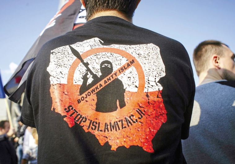 ACTIVISTS PROTEST against refugees in Lodz, Poland in September 2015. The words on the shirt read, ‘Anti-Islam militia. Stop Islamization.’