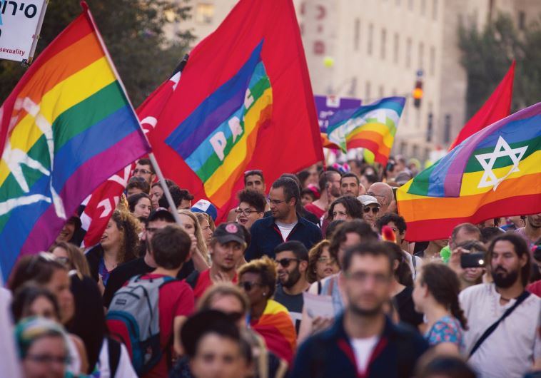 LGBT supporters flood the capital’s streets and wave custom pride flags, after the murder of Shira Banki at the city’s pride parade last July