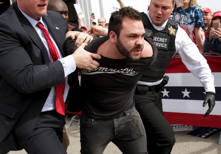 US Secret Service agents detain a man after a disturbance as US Republican presidential candidate Donald Trump spoke at Dayton International Airport in Dayton, Ohio March 12, 2016.
