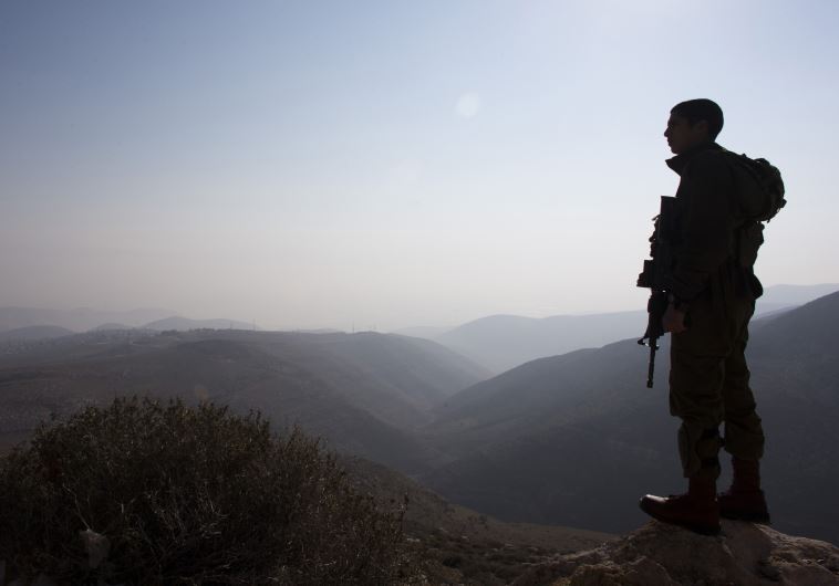 An IDF soldier stands guard during a tour made by Israeli parliament members in the Jordan Valley [File]