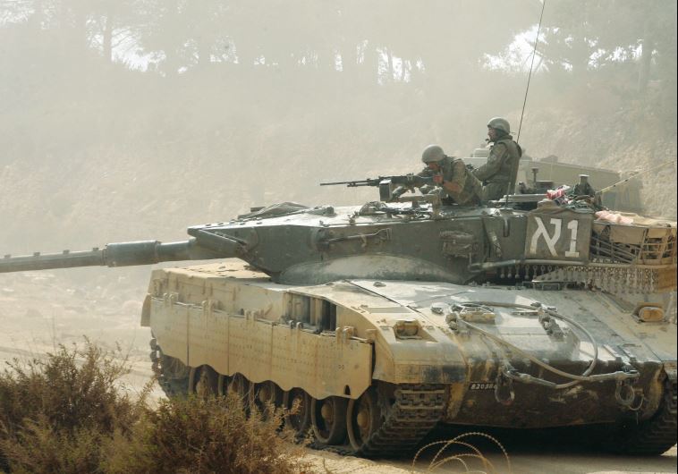 An Israeli tank moves along the border with Lebanon in August 2006
