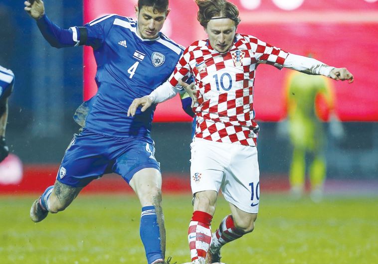 Israel midfielder Nir Biton (left) battles Croatia’s Luka Modric for the ball during last night’s 2-0 defeat in an international friendly in Osijek