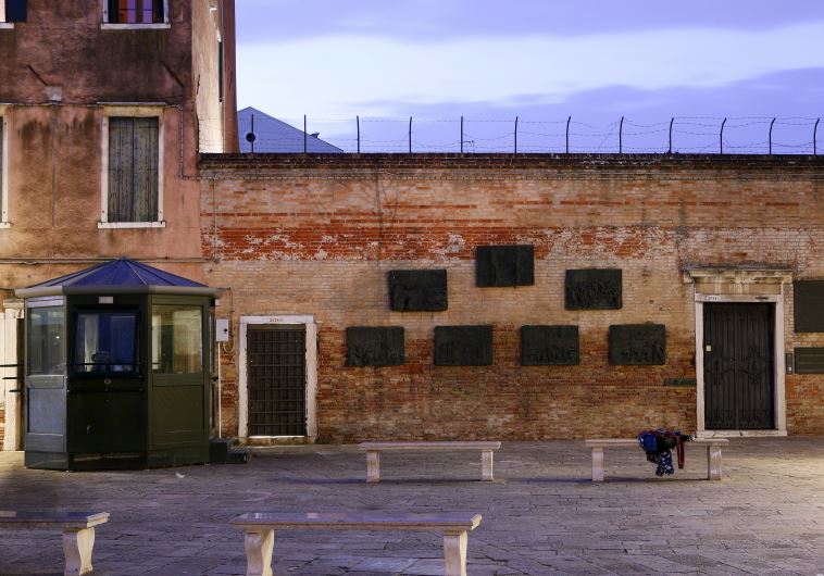 A police security kiosk stands to the left of a memorial to the victims of the Holocaust in the “campo,” or square, at the centre of the world’s first ghetto, in Venice northern Italy, March 22, 2016