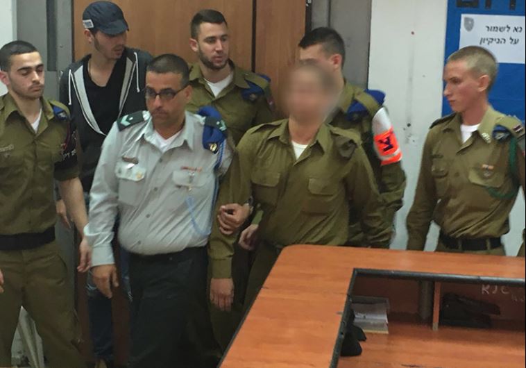 IDF soldier who shot a neutralized Palestinian terrorist in Hebron being led into court, March 29, 2016