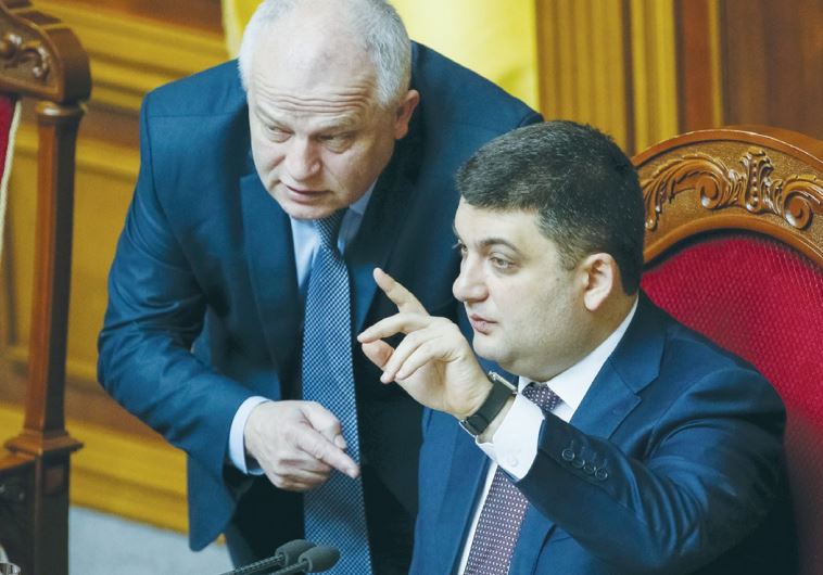 UKRAINIAN PARLIAMENT SPEAKER Volodmyr Groysman (right) speaks with Stepan Kubiv, President Petro Poroshenko’s representative in parliament, during a session in Kiev on March 29.