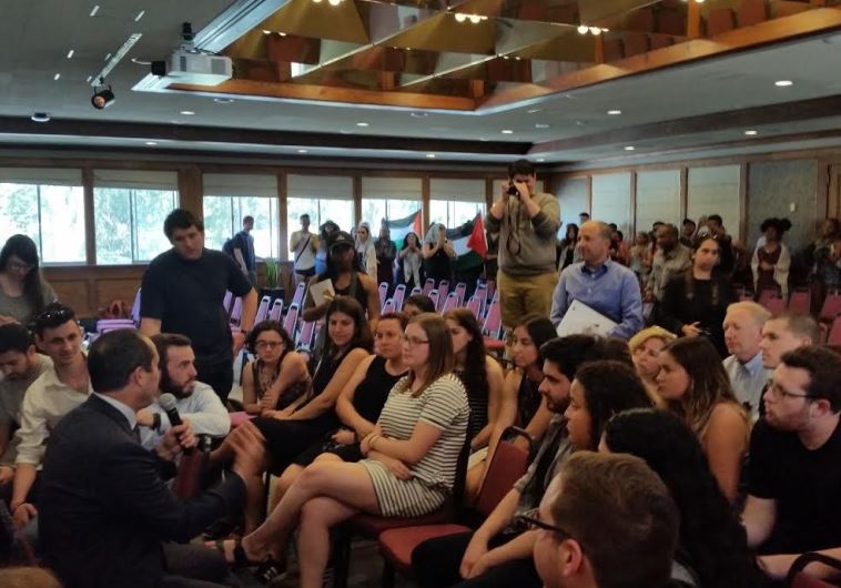Anti-Israel protesters crash Jerusalem mayor Nir Barkat's (bottom left) talk at a San Francisco university
