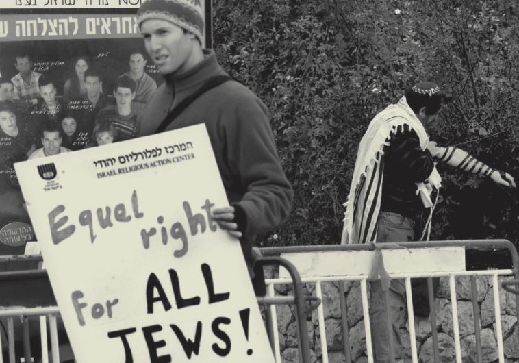 Protester holds a poster demanding equal rights for all Jews