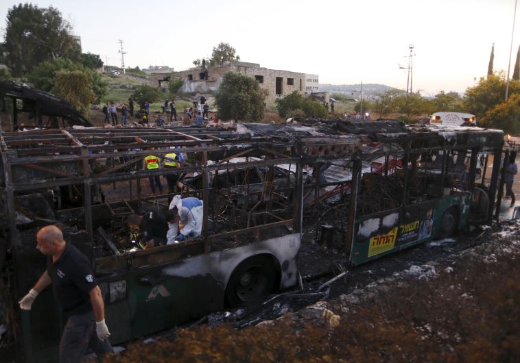 Police forensic experts work at the scene after an explosion tore through a bus in Jerusalem