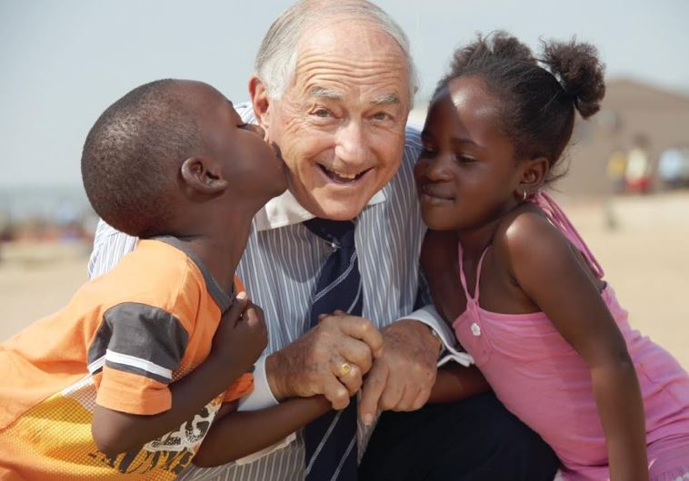 BERTIE LUBNER with two of many disadvantaged children he helped in South Africa
