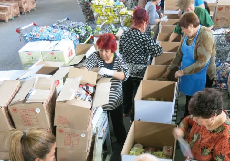 VOLUNTEERS PREPARE food packages for the needy ahead of Passover at a Kolel Chabad center earlier this week