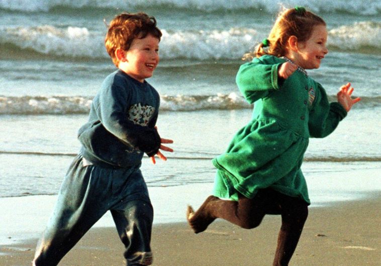 Children enjoy a sunny winter day on a Tel Aviv beach