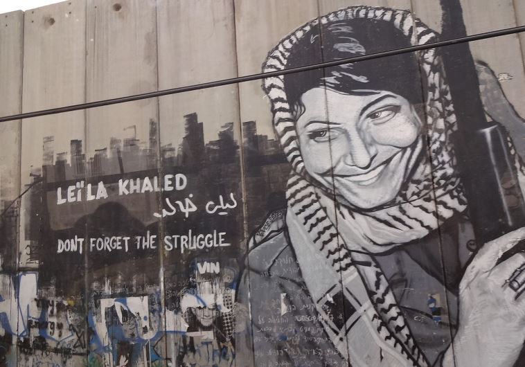 Graffiti depicting the PFPL plane hijacker Leila Khaled on the security barrier near Bethlehem