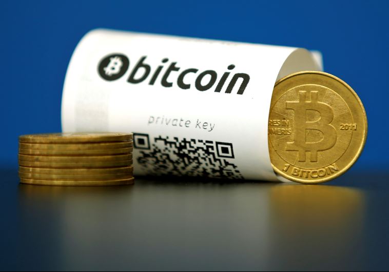 A Bitcoin (virtual currency) paper wallet with QR codes and a coin are seen in an illustration picture taken at La Maison du Bitcoin in Paris, France, May 27, 2015