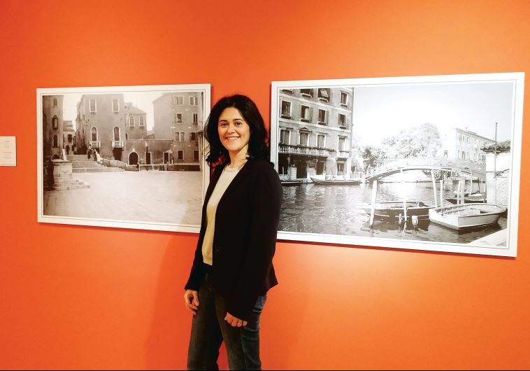 Curator Micol Schreiber Benarroch with a photograph of her grandmother’s house in Venice