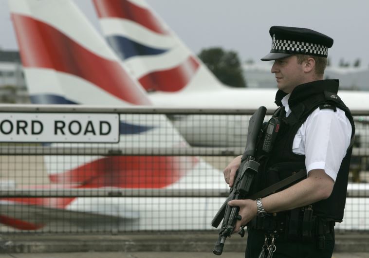 An armed policeman patrols Heathrow Airport, London