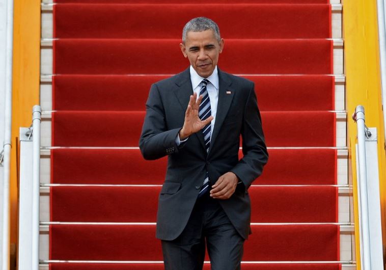 US President Barack Obama waves as he arrives at the Tan Son Nhat airport in Ho Chi Minh City