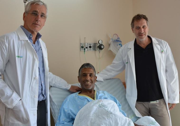 From right, Dr. Evyatar Nesher, deputy head of Beilinson transplant department, kidney recipient, and Prof. Eitan Mor, head of the department 