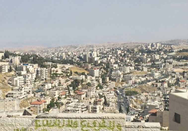 A VIEW from a-Tur of Arab neighborhoods in east Jerusalem, with Abu Dis, beyond the security barrier, in the distance.