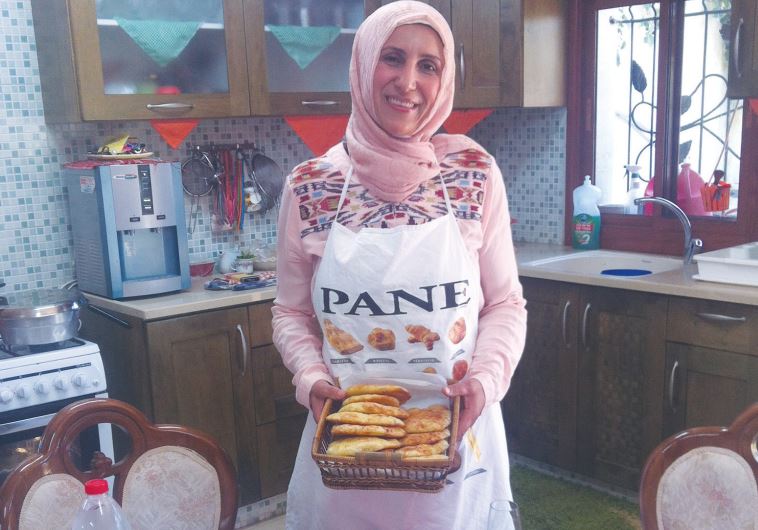 MANAL KARAMAL JEBEREEL, a private caterer, makes iftar meals for families in her home in Umm al-Fahm.